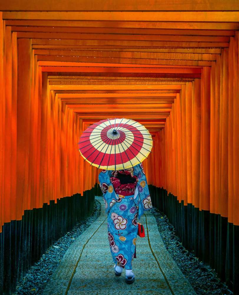 Asian women in traditional japanese kimonos at Fushimi Inari Shrine in Kyoto, Japan.